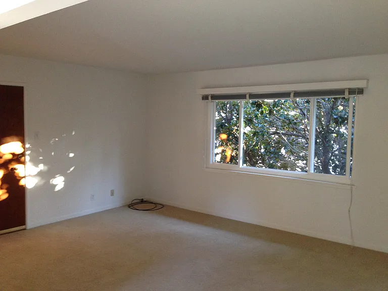 Living room with large window overlooking the courtyard