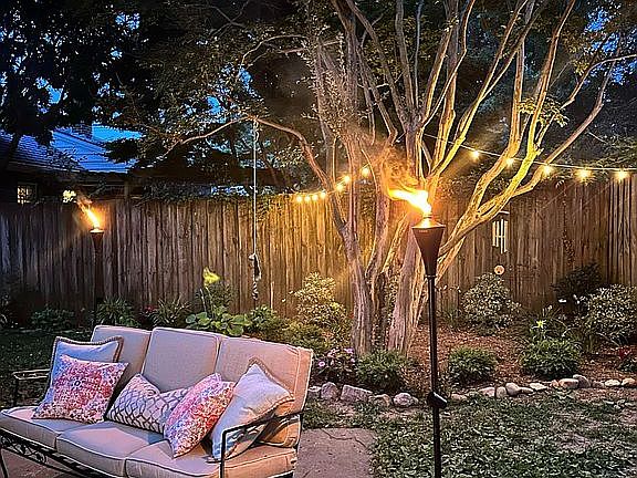Cozy backyard aesthetic with ample privacy and newly landscaped beds