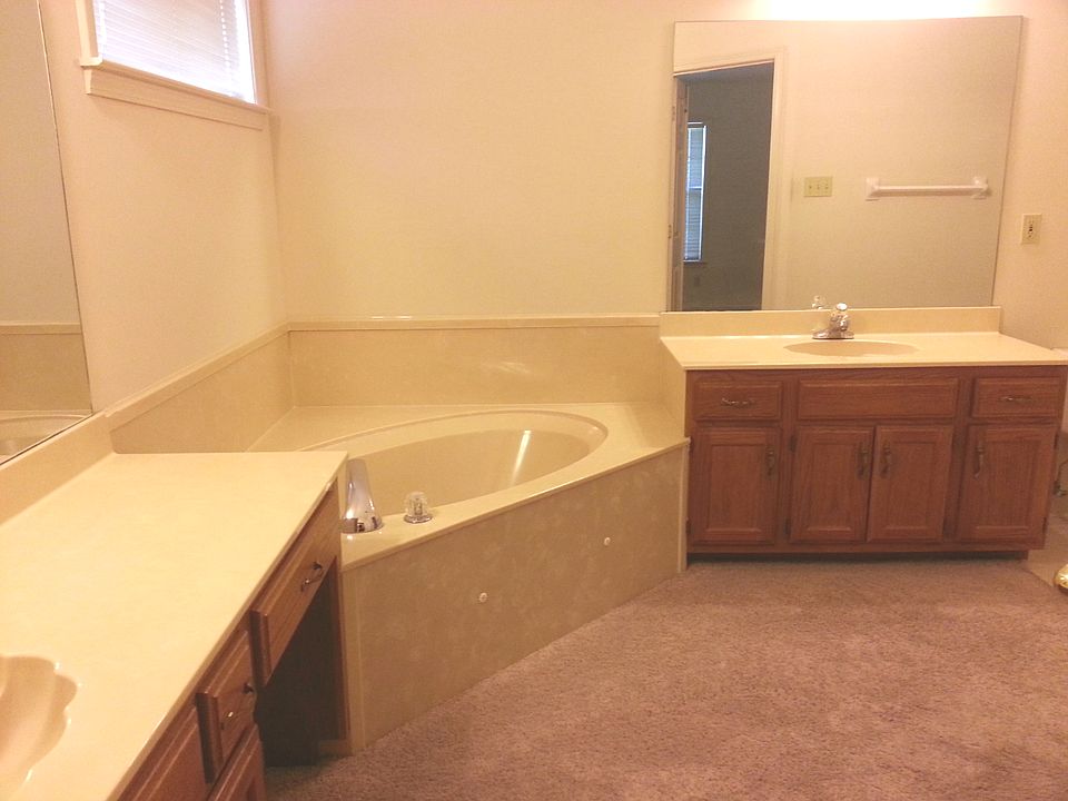 Master bath with jacuzzi tub, his and her vanity, and walk-i