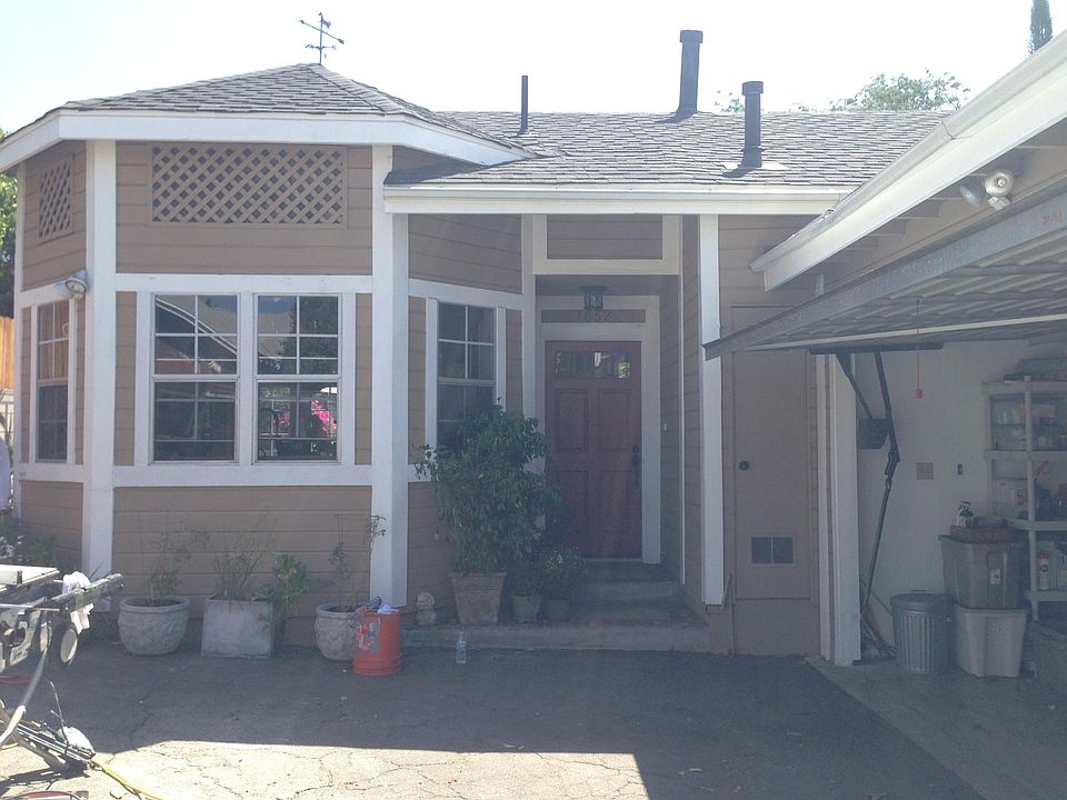 older picture of the front of the house before it was painted light gray with the white trim. The windows are all the kitchen.