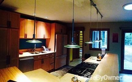 Large open Family Kitchen
						:
						Rich lighting accents the wood-theme. Perfect for culinary artists.