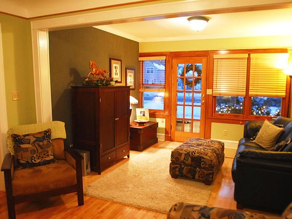 Living room features new maple flooring & divided light entry door.