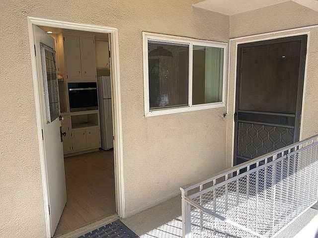 The door to the left opens up to the kitchen, the front door on the right opens up to the living room.