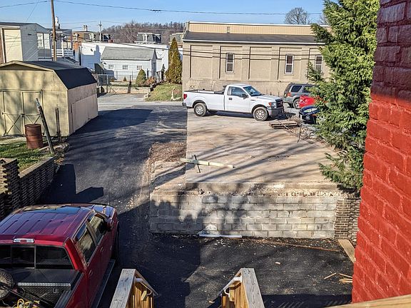 Exterior steps leading to rear (Avenue G) parking lot; one off-street parking spot included with rent!