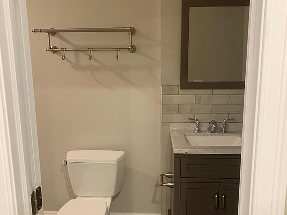 Bathroom with towel rack above the toilet
