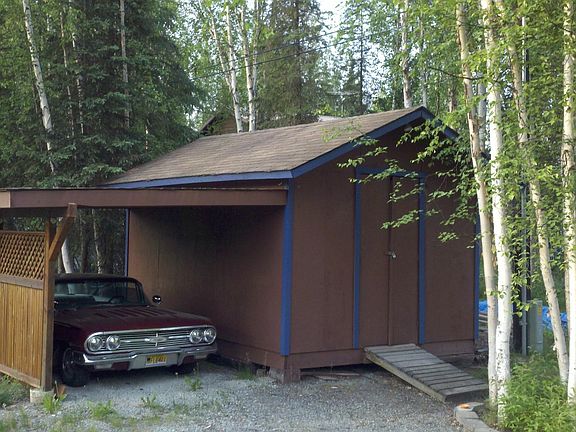 Large storage shed and single car carport.