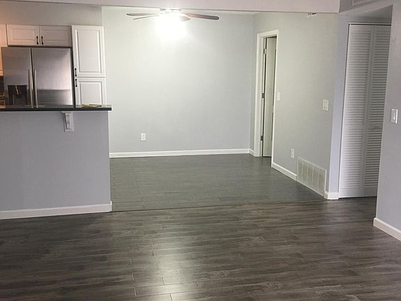 Living room facing kitchen and laundry from sliding glass doors