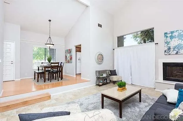 raised dining room area. Sunken living room with high ceilings and fireplace.