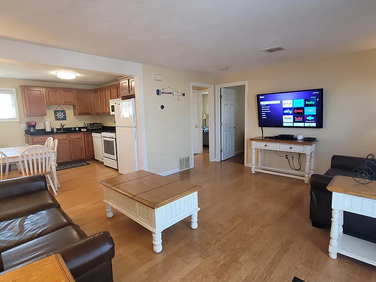 Large open living room space open to the kitchen. Hardwood floors. Central A/C