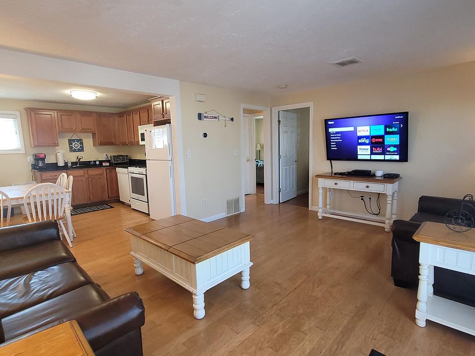 Large open living room space open to the kitchen. Hardwood floors. Central A/C