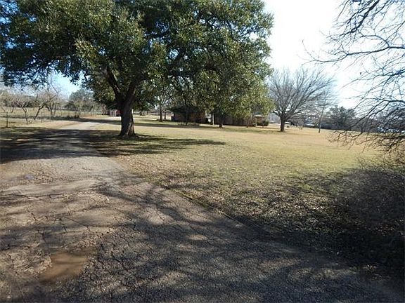 Driveway runs along the north side of the property line to the main house.