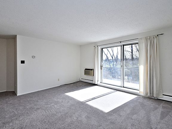 Sunny living room with sliding door to balcony