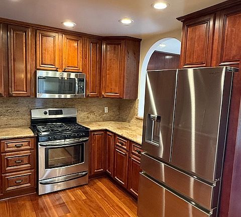 Gourmet kitchen with granite counter top and all stainless steel appliances.