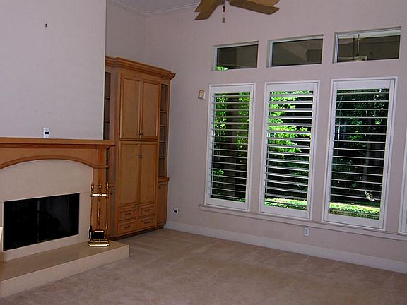 Family room has direct access to covered patio and has abundant built ins and gas log fireplace.