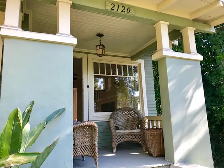 Front porch overlooking verdant meadow