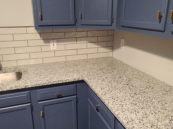 Renovated kitchen - new tile floor, new stainless steel appliances, new granite countertop with tile backsplash