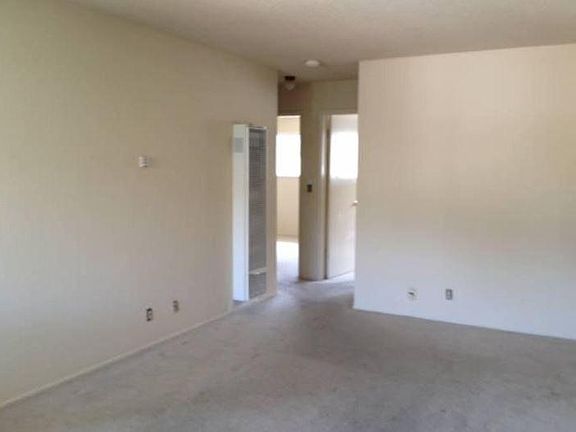 new carpet and wall furnace in living room