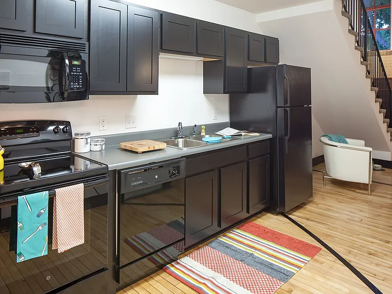 Kitchen with black cabinets at 3 Points Loft.