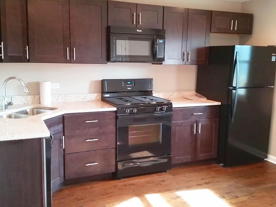 View of the kitchen, with solid wood cabinets and newer appliances, recently updated.
