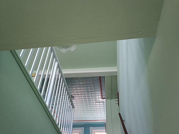 up the stairs to original tin ceiling room