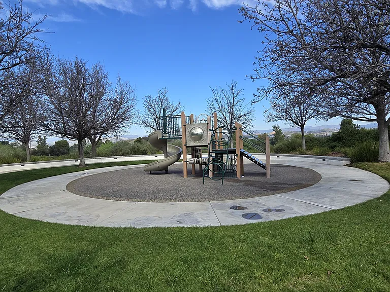 Gated community play area with open space and family-friendly setting