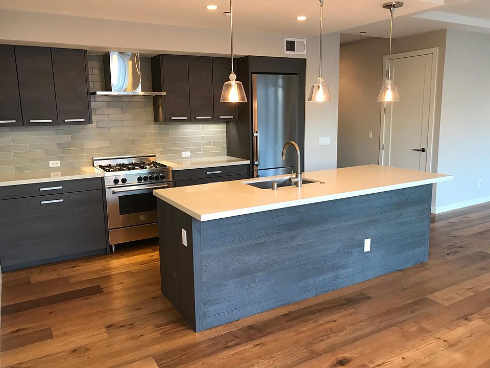 Gourmet Chef's Kitchen with high-end stainless steel appliances, Quartz countertops, and Heath tile