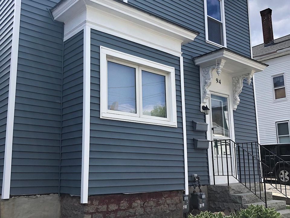 Front view w new siding and windows.