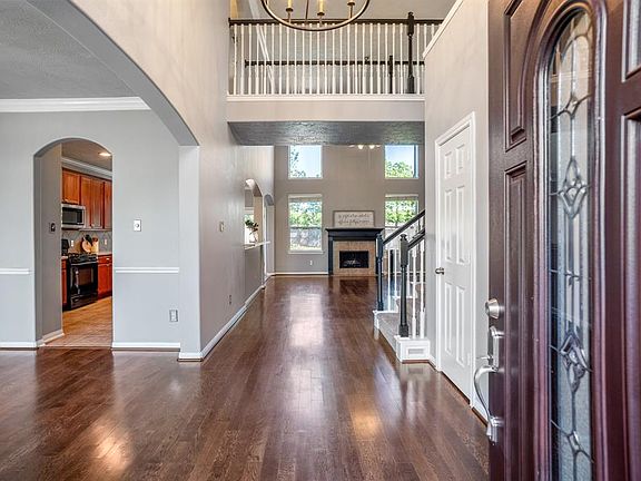 Gorgeous 2- story foyer, with gleaming hardwoods, crown molding and custom light fixtures.