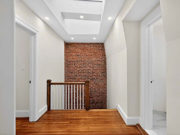 Third floor atrium flooded with natural light due to three large skylights.