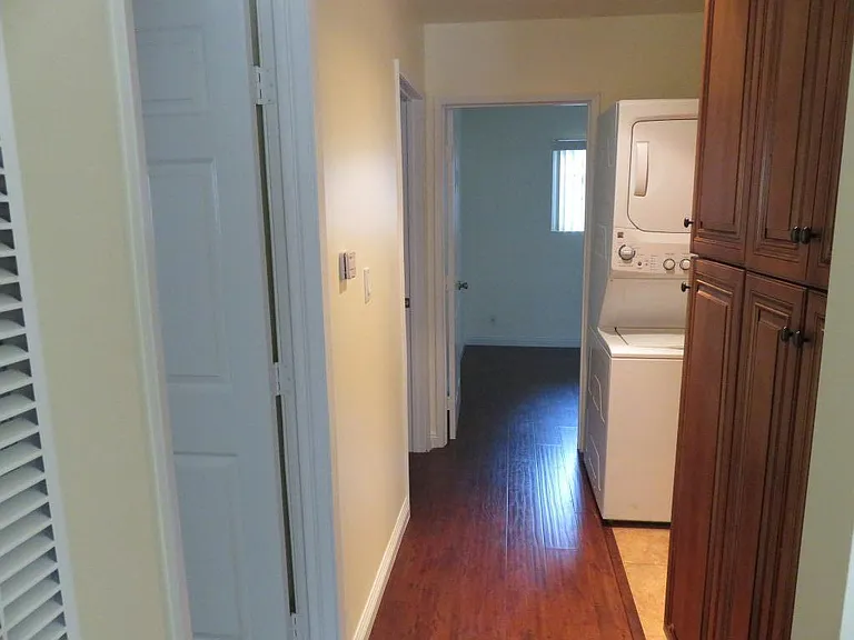 View is looking down the hallway from living area. Two bedrooms to left and one straight ahead. To right, is bathroom.