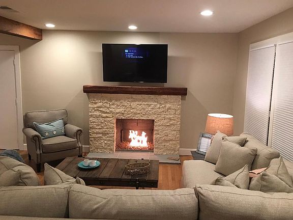 Living room with gas fireplace and professionally mounted tv