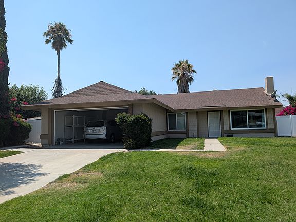 Front of house, main entrance door leading to living room. The window to the left of the entrance belongs to a bedroom.
