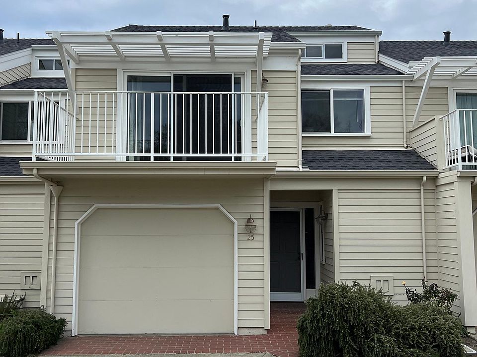 Exterior with attached garage with balcony
