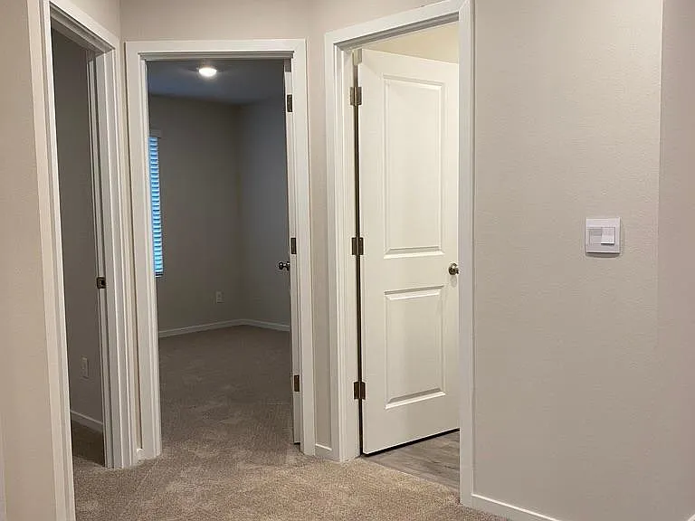 View from the top of stairs. Two bedrooms and full hallway bathroom.