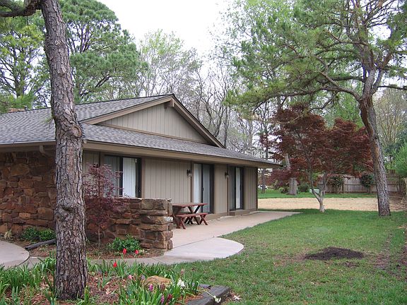 East patio with doors from each of the 3 bedrooms. A fence w