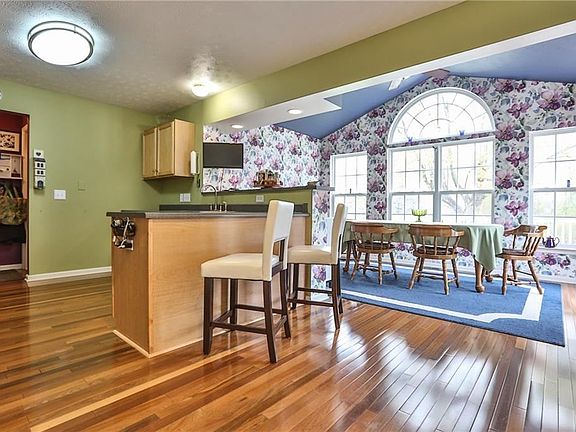 Kitchen area is open, spacious and sun filled.  Gleaming natural wood floors throughout the first floor.
