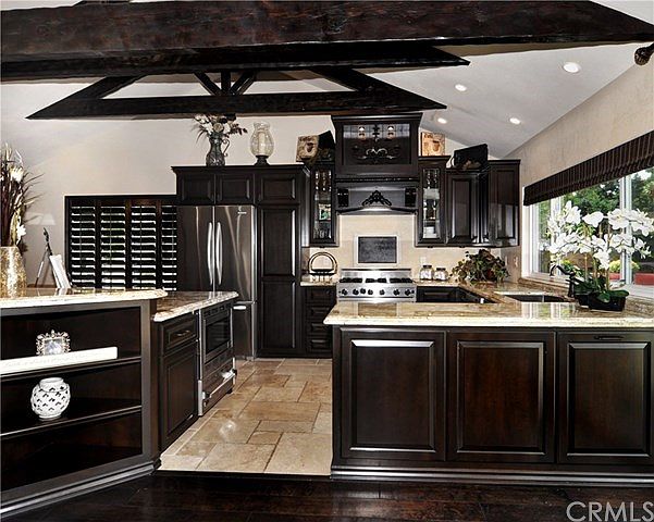 Incredible custom Kitchen that has all attention to detail. Glazed Expresso Cabinets, with custom hood, and shelf and lights. Co