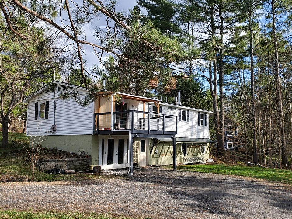 surrounded by trees this house has a spacious driveway and a nice lawn space in the back and front
