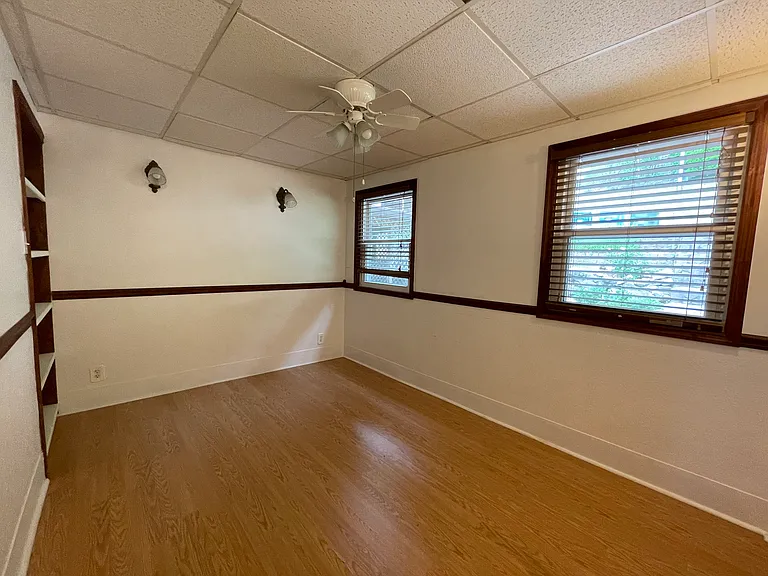 Office/Bedroom 4: 8.5'x12' Ceiling has been drywalled since photo. Built in bookcase.
