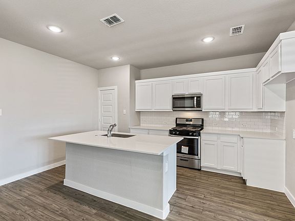 Kitchen in the Willow home plan by Trophy Signature Homes - REPRESENTATIVE PHOTO