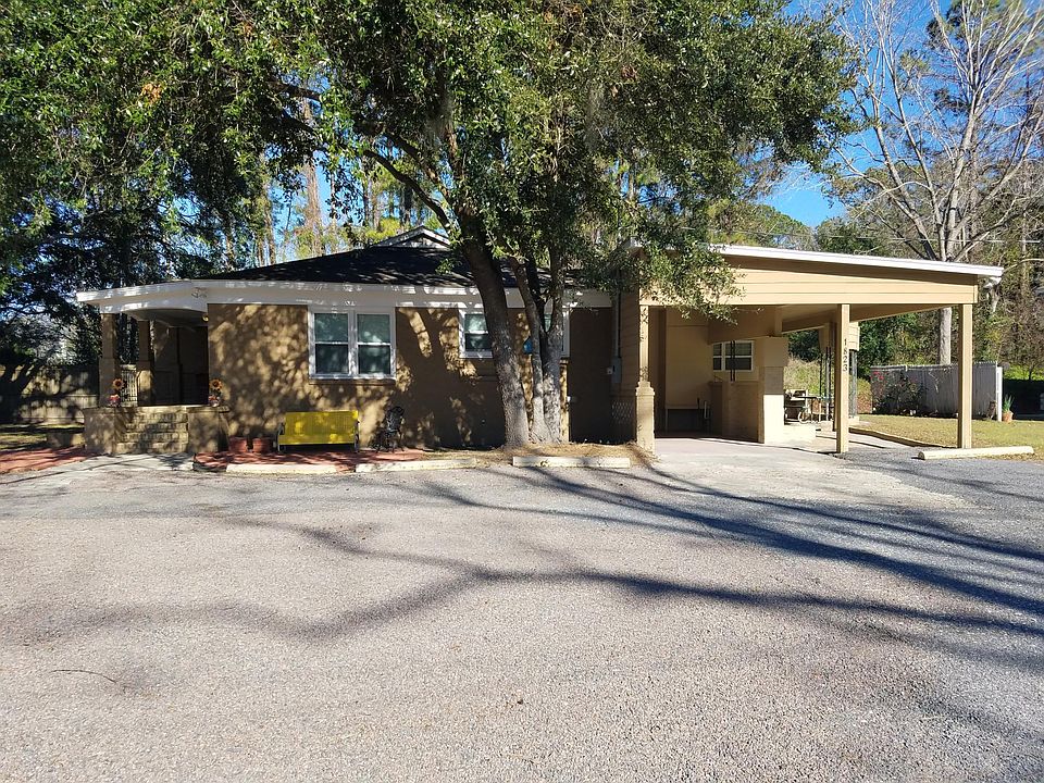 Welcoming front with red paver patio and yellow glider