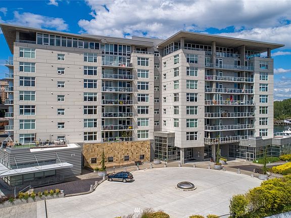 Welcome to the sought-after Esplanade condominiums along the Foss Waterfront in Tacoma.  A mere minute from I-5 but several worlds away!  Underground secure parking, two storage units, gym, event room, residential lounge and newly completed guest parking.>