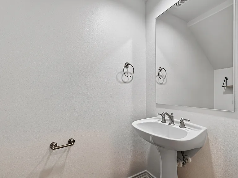 Convenient half bath located just off the main living area.