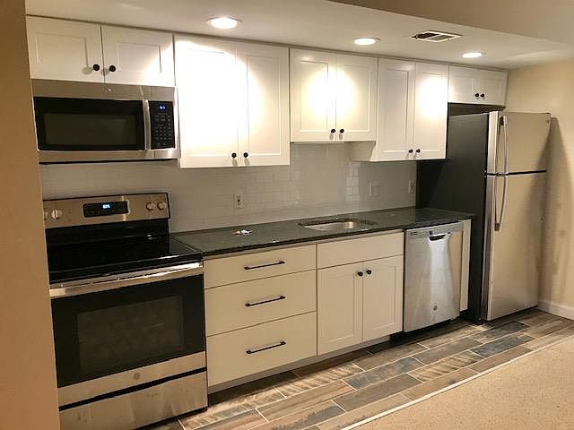 Brand new kitchen. Shaker style cabinetry, black granite countertop, subway tile backsplash and all brand new GE appliances.