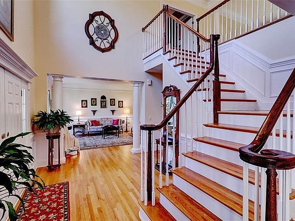 Two story Entry. Hardwoods throughout. Dentil Molding above Front Door. Double-wide crown molding & wainscoting accentuate lovel