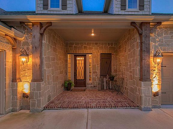 A large front covered porch  welcomes your guests!