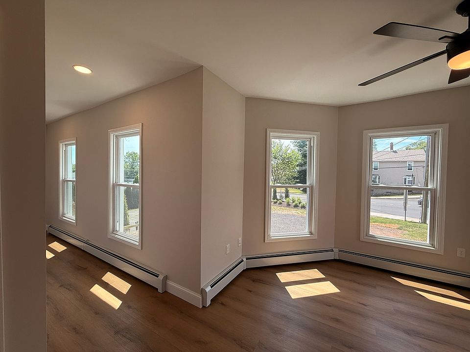 LIVING ROOM - large beautiful windows, tons of natural light and lots of space. All new fixtures and finishes.