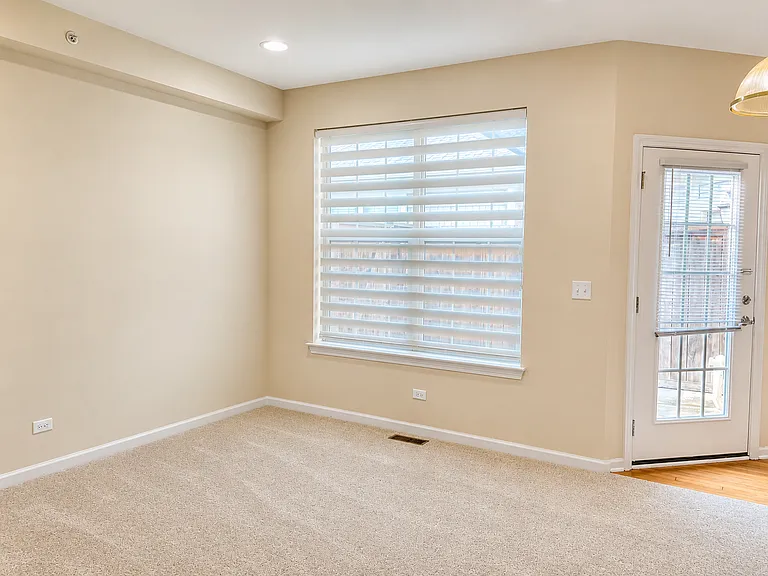 Family room with a large window and direct access to the patio.