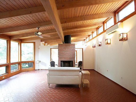 Living area from foyer. Wood burning fireplace. Extra studio/home office on other side.