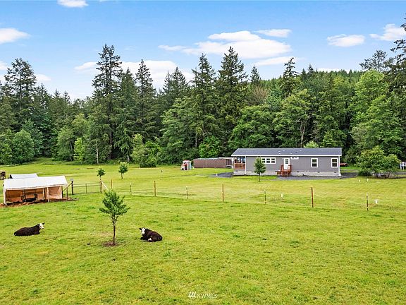 Happy cows & people enjoy the sweet life on this level 5.88 acres with a beautiful blend of fenced pastures & trees. 
